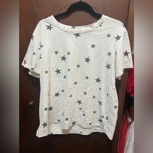 white shirts with black stars and is distressed at the collar.